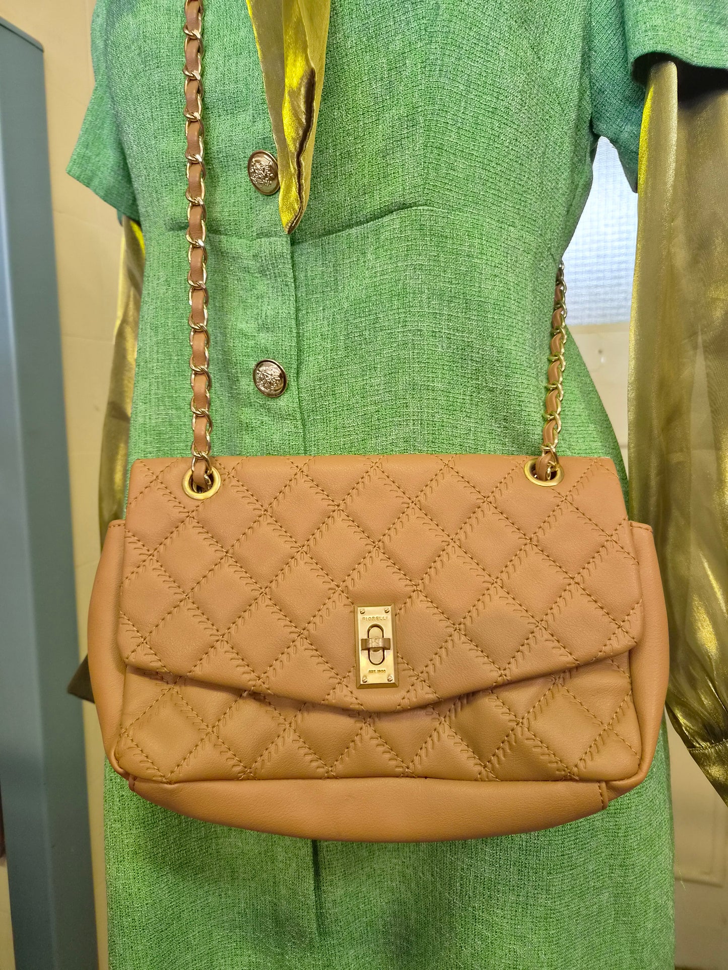 Fiorelli quilted shoulder bag features a distinctive gold clasp and a matching chain strap