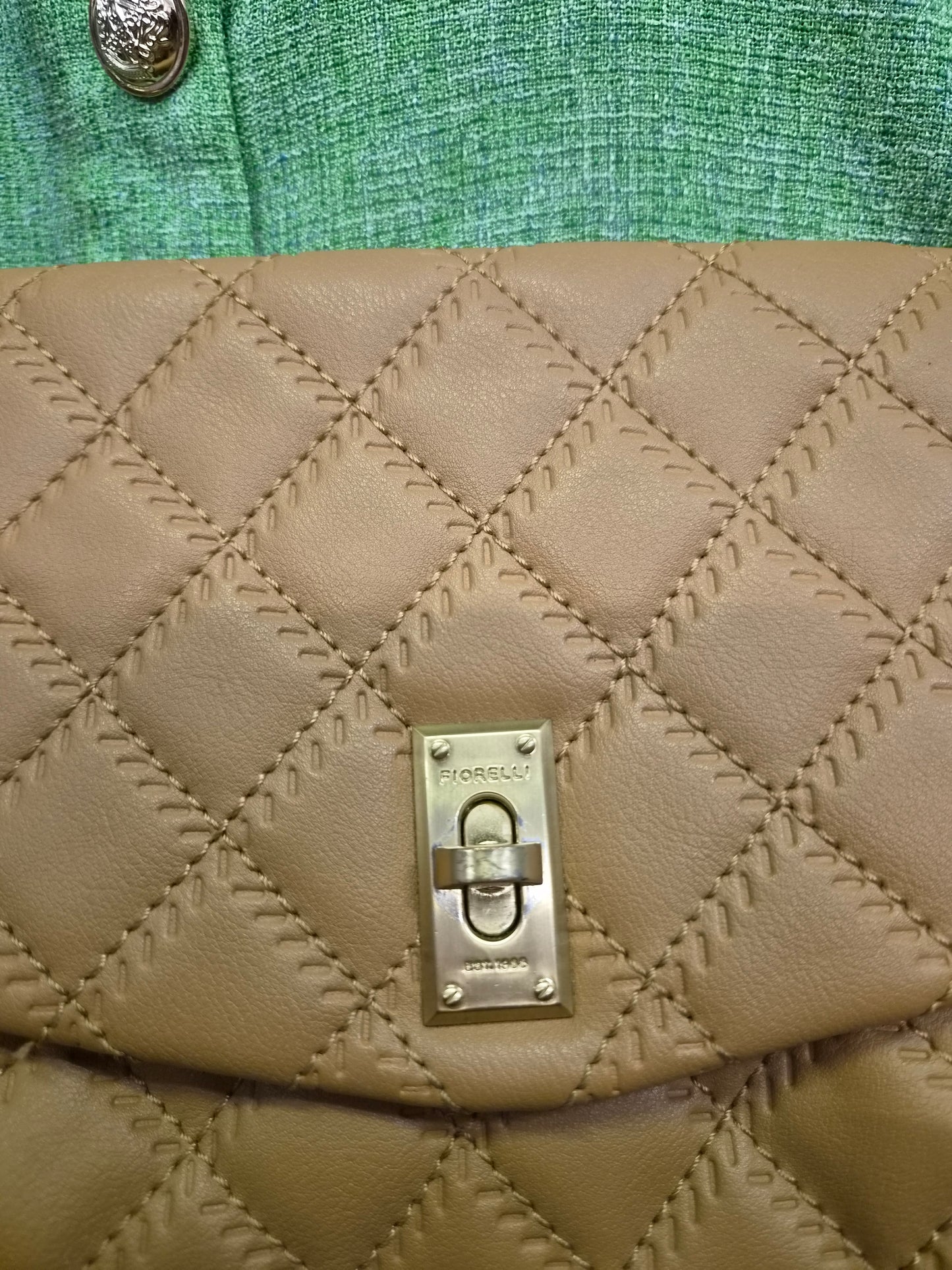 Fiorelli quilted shoulder bag features a distinctive gold clasp and a matching chain strap