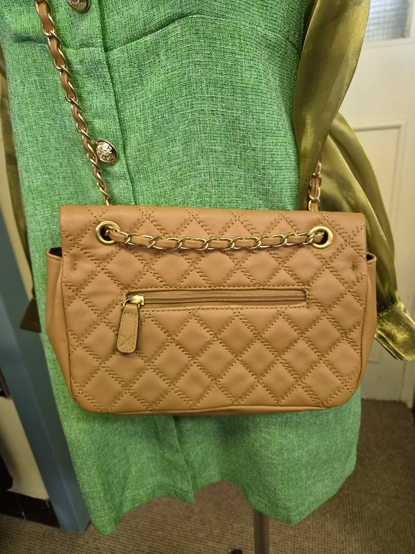 Fiorelli quilted shoulder bag features a distinctive gold clasp and a matching chain strap