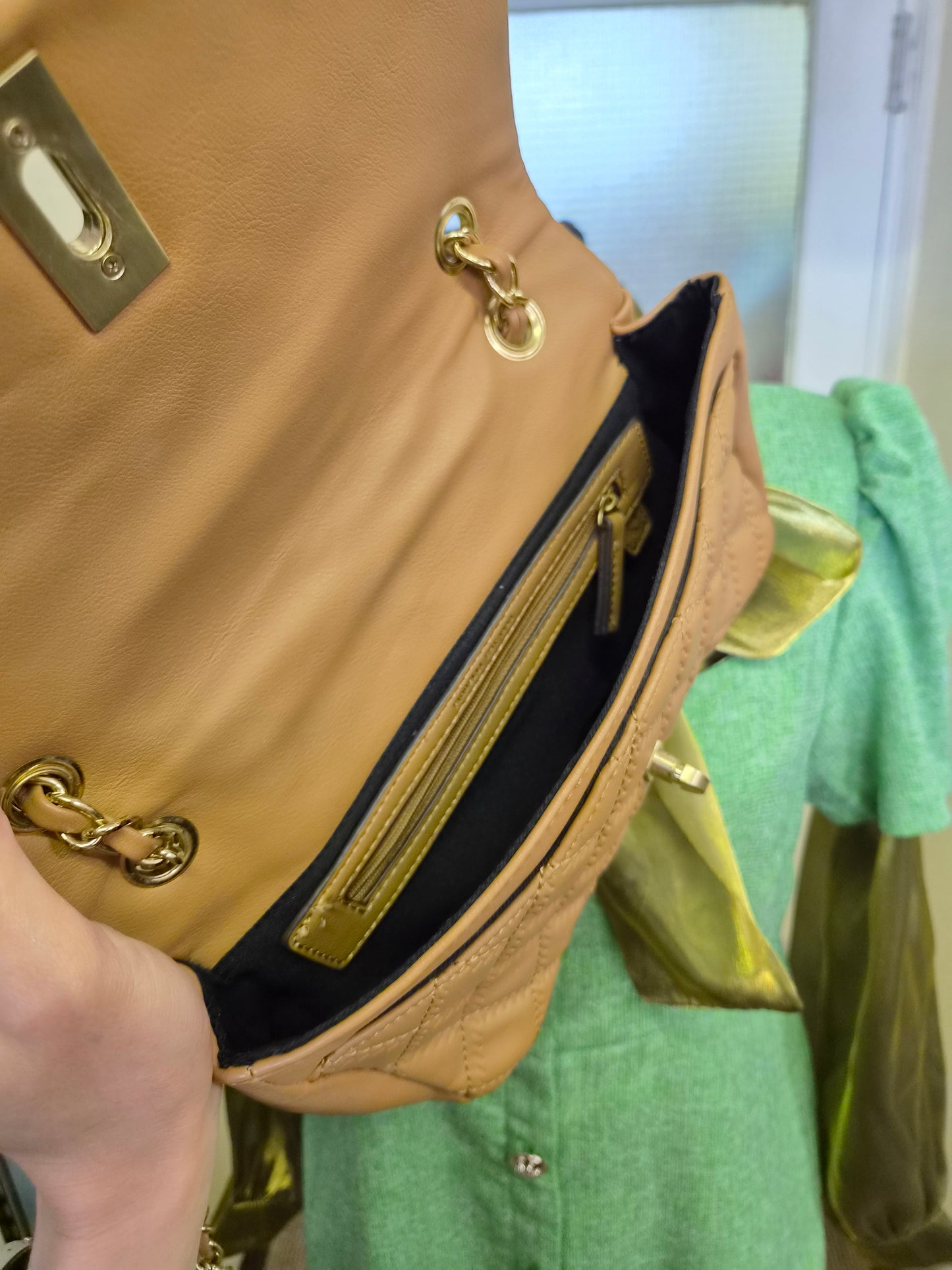 Fiorelli quilted shoulder bag features a distinctive gold clasp and a matching chain strap