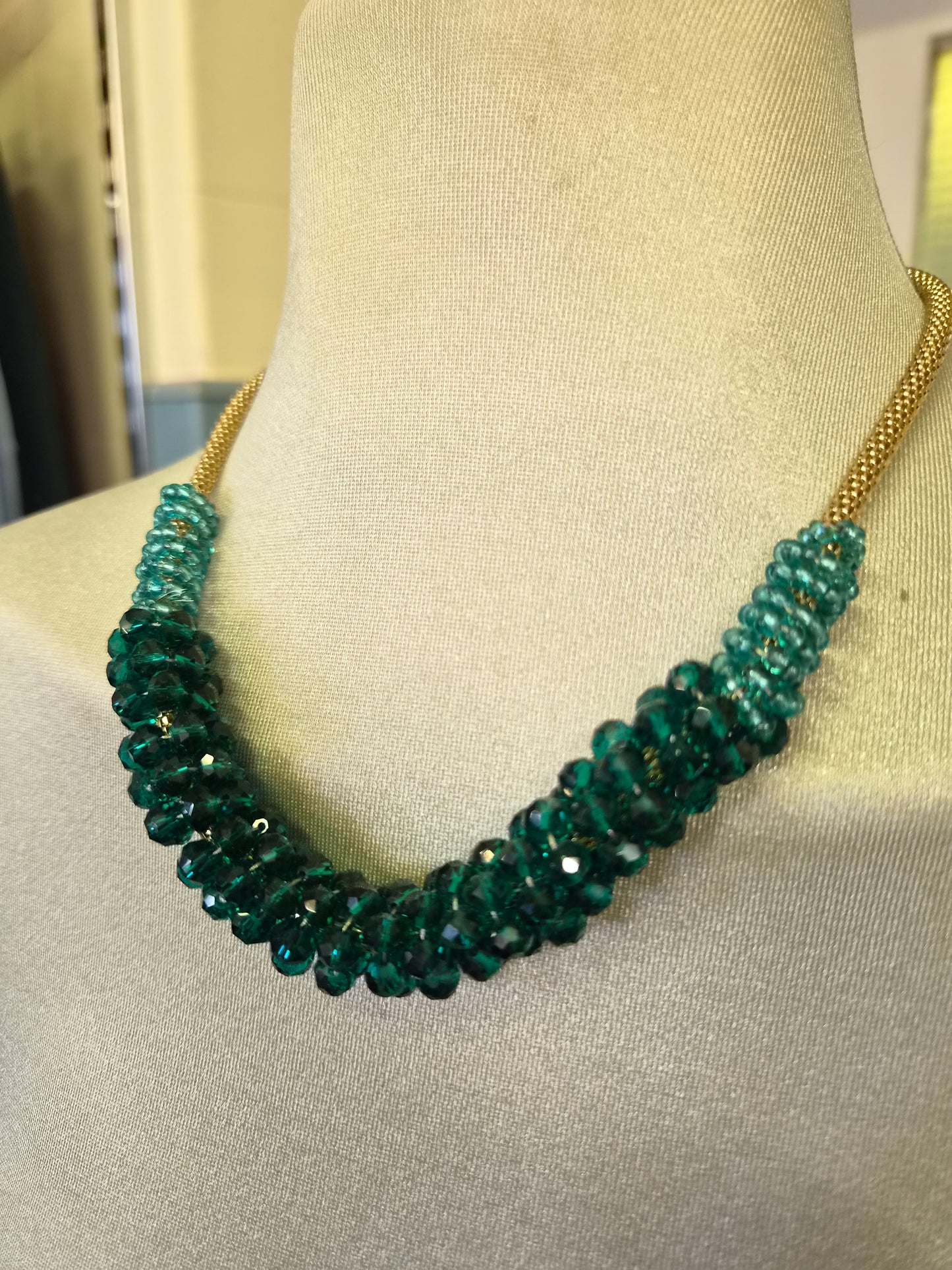 Green beads on a golden chain
