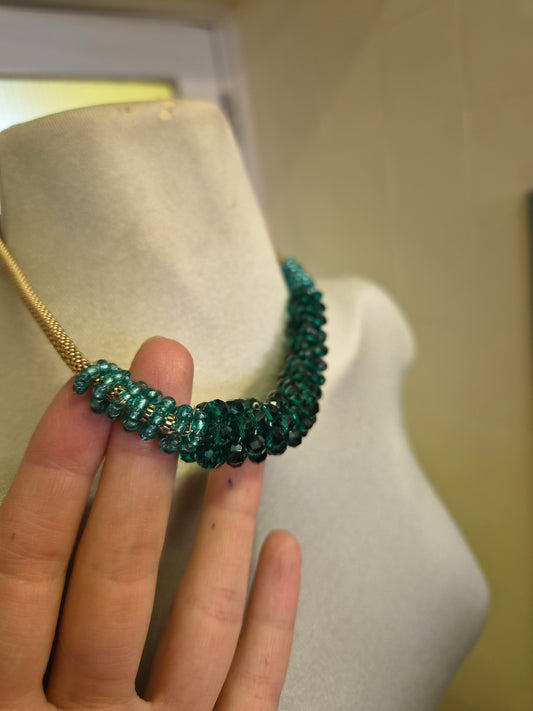 Green beads on a golden chain